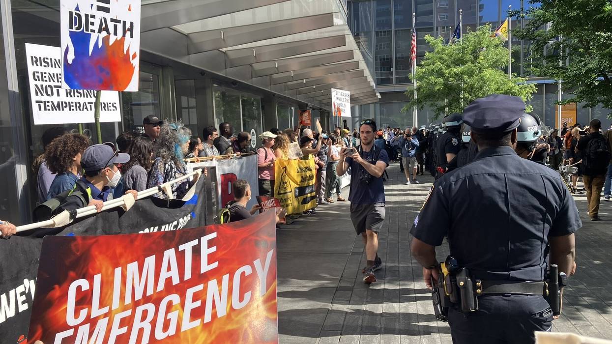 climate protestors holding banners