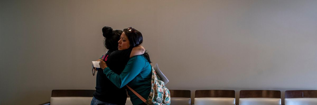 Clinic worker embraces patient