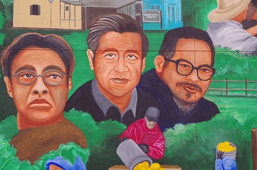 Close of up the mural in old town Delano, California depicting Larry Itliong, Cesar Chavez, Philip Vera Cruz.