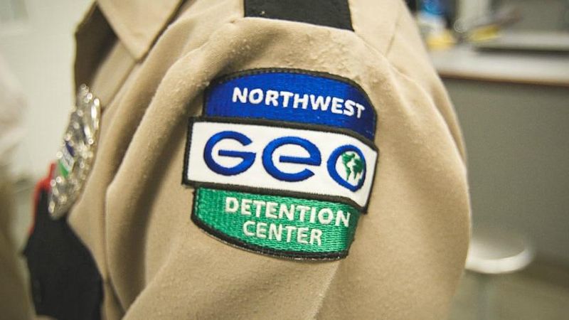 Close-up of private prison guard badge.