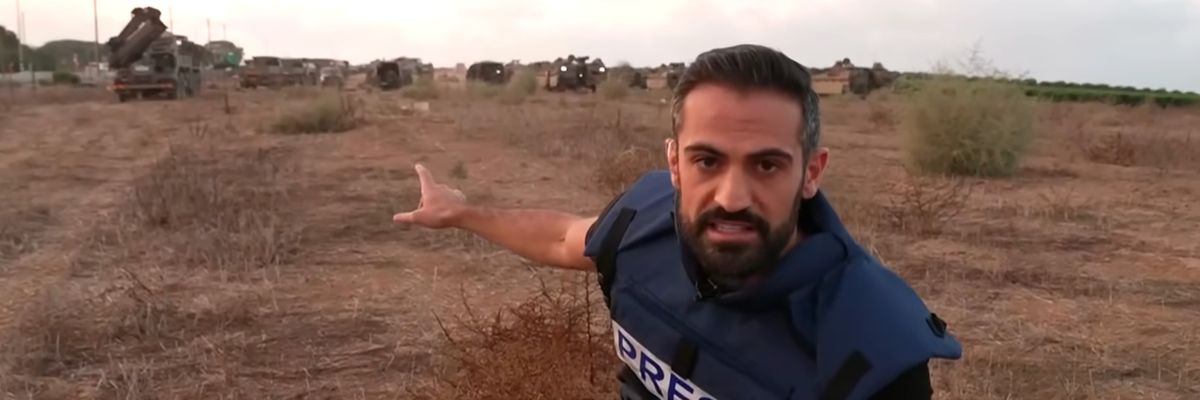 CNN's Jeremy Diamond points to IDF tanks and hardware in a field near Israel's border with Gaza.