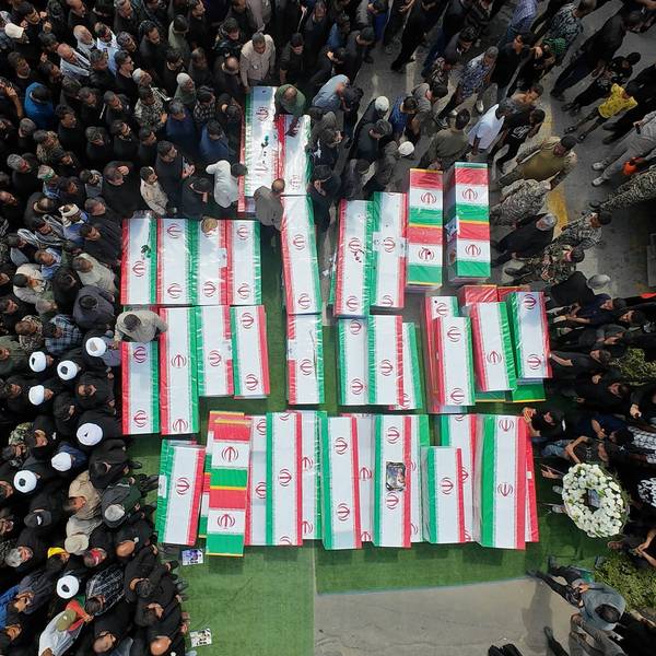 Coffins of victims of the US strike on a girls' school in Minab, Iran are surrounded by mourners