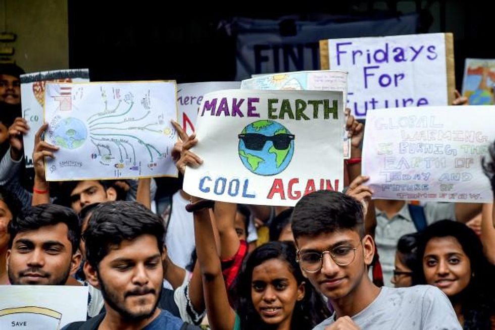 College students hold posters while participating in a 'Fridays for Future' climate strike to protest against governments' inaction towards climate breakdown and environmental pollution in Mumbai on September 20, 2019. (Photo by Indranil Mukherjee/AFP/Getty Images)