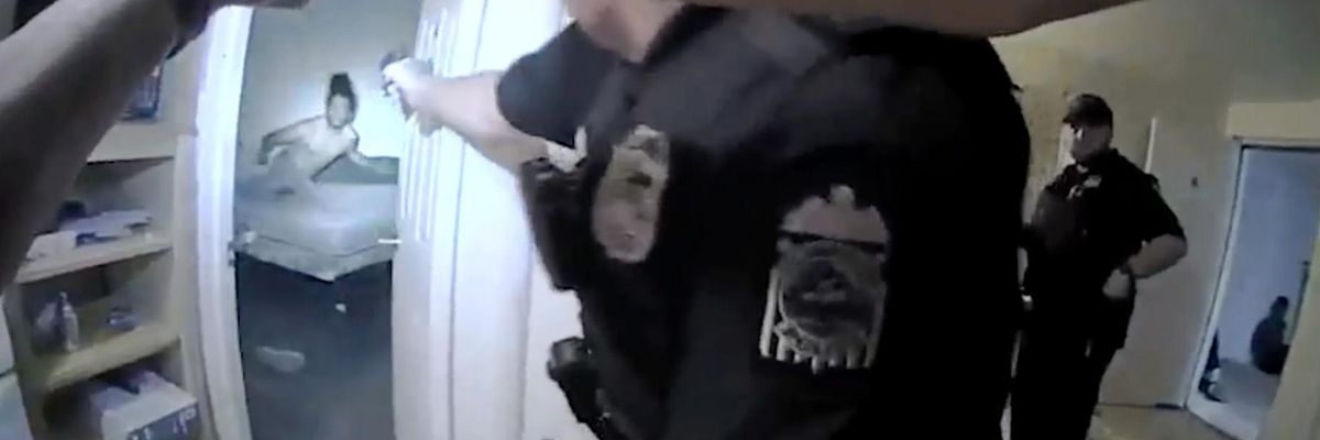 Columbus Police Department Officer Ricky Anderson aims a gun at 20-year-old Donovan Lewis