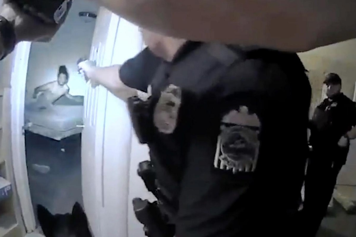 Columbus Police Department Officer Ricky Anderson aims a gun at 20-year-old Donovan Lewis