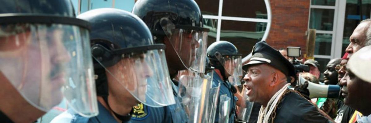 Community members confronted a line of police officers in Ferguson, Missouri
