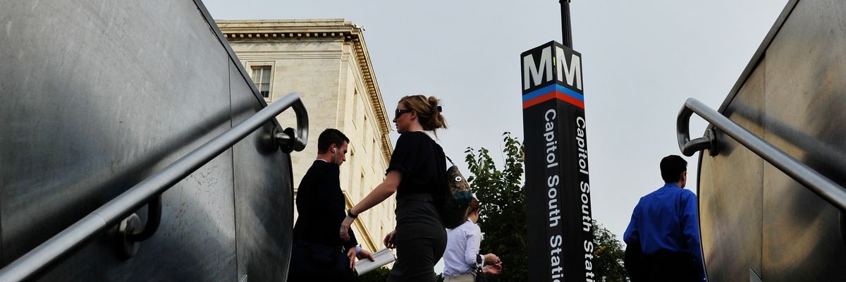 Commuters are seen outside of the Capitol South Metro Station