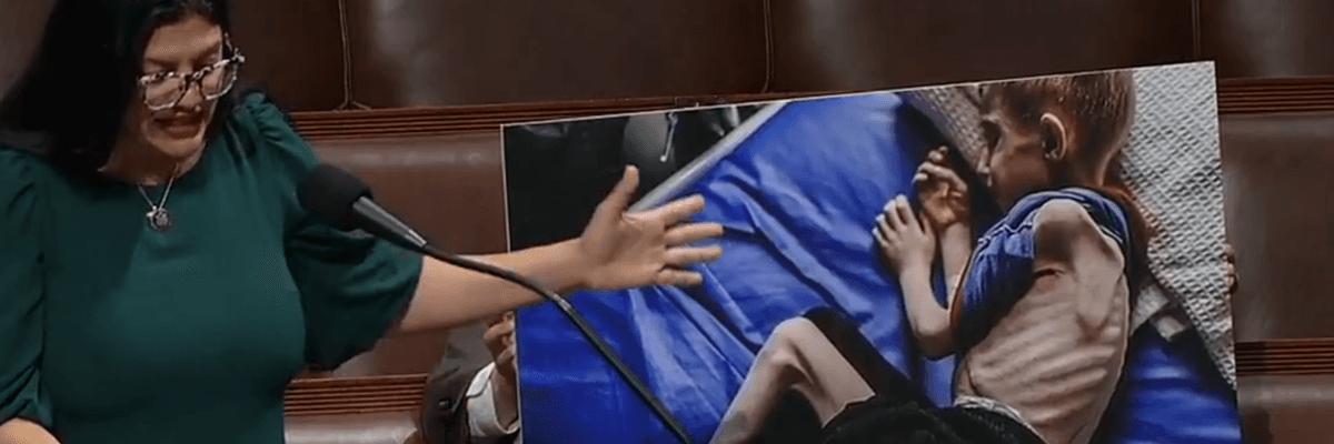 Congresswoman Rashida Tlaib speaks on the House floor pointing to a photo of a starving Gazan child