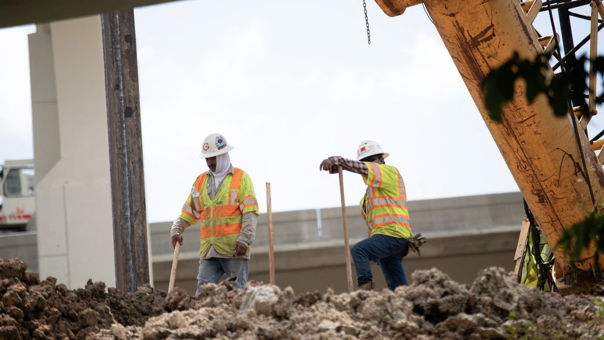 Construction workers rebuild the I-69 Southwest/I-610 West Loop Interchange during a heatwave in Houston