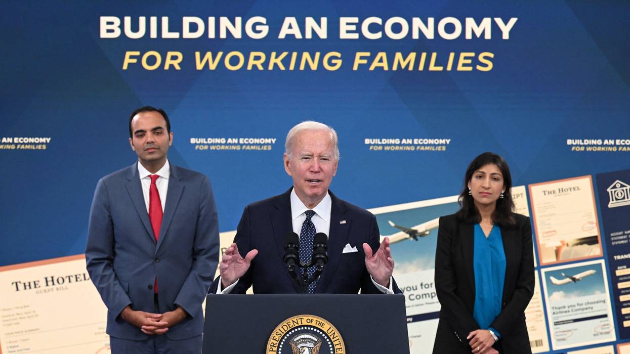 Consumer Financial Protection Bureau Director Rohit Chopra (L) and Federal Trade Commission Chair Lina Khan (R) listen as U.S. President Joe Biden speaks in Washington, D.C. on October 26, 2022.
