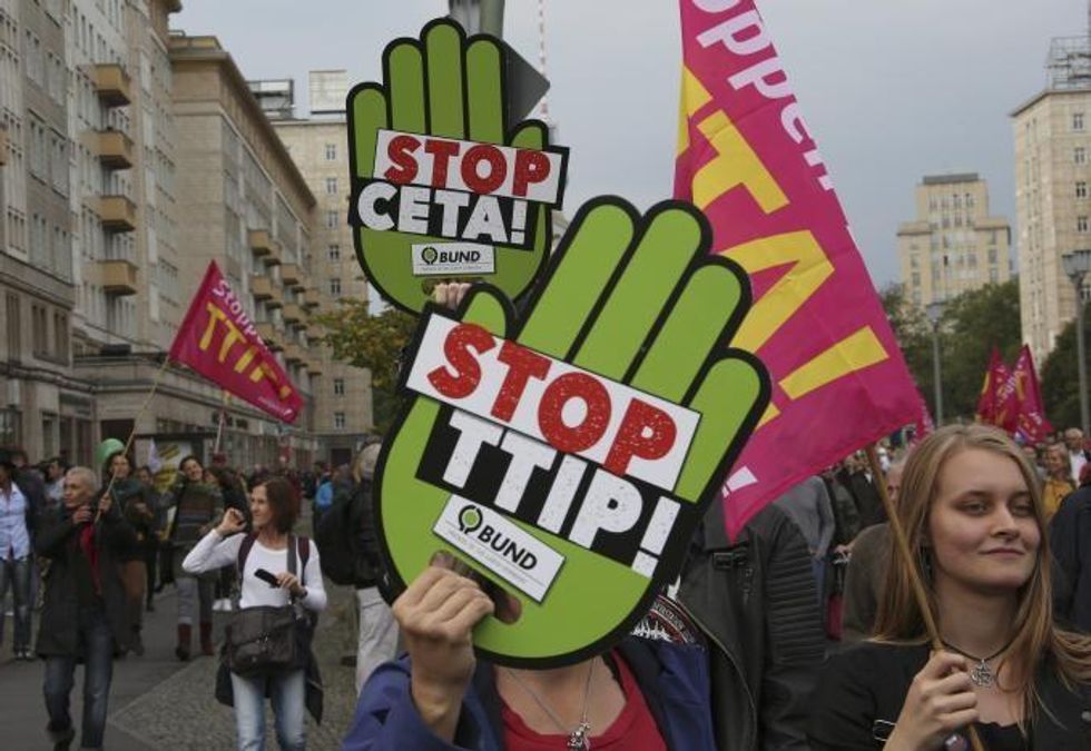 Consumer rights activists take part in a march to protest against the Transatlantic Trade and Investment Partnership (TTIP) and Comprehensive Economic and Trade Agreement (CETA) in Berlin, Germany, September 17, 2016. REUTERS/Fabrizio Bensch