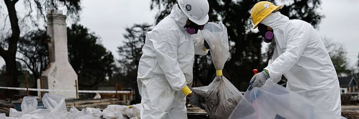 contractors in protective gear remove hazardous materials from a home destroyed in the Eaton Fire