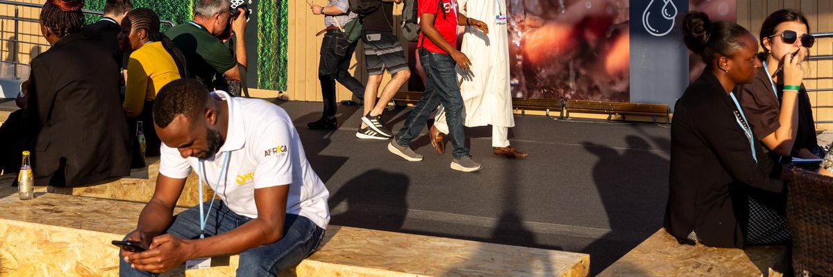 COP27 attendee looks at his smart phone