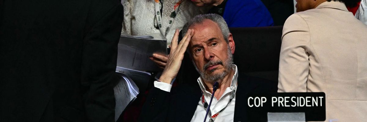 COP30 President puts his head in his hand.