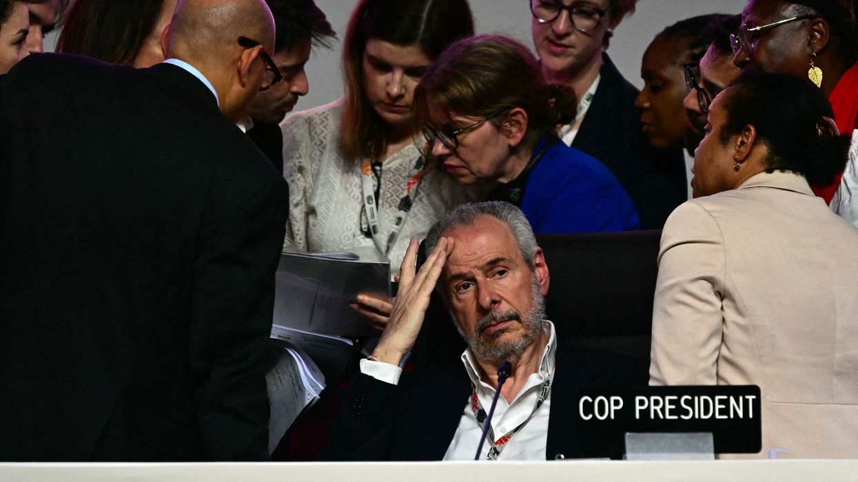 COP30 President puts his head in his hand.