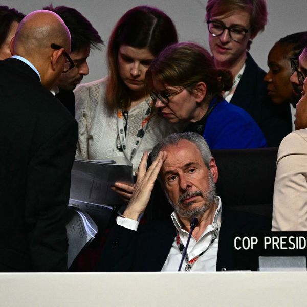 COP30 President puts his head in his hand.