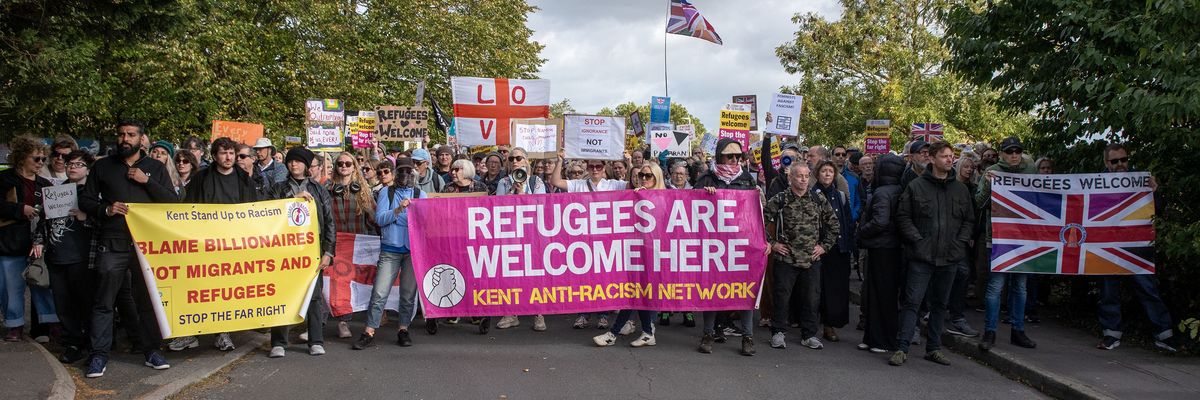 Counter-protester hold their banners, placards and flags...