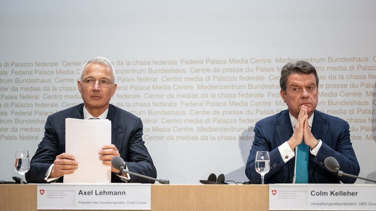 Credit Suisse chairman Axel Lehmann (L) and UBS Chairman Colm Kelleher attend a press conference
