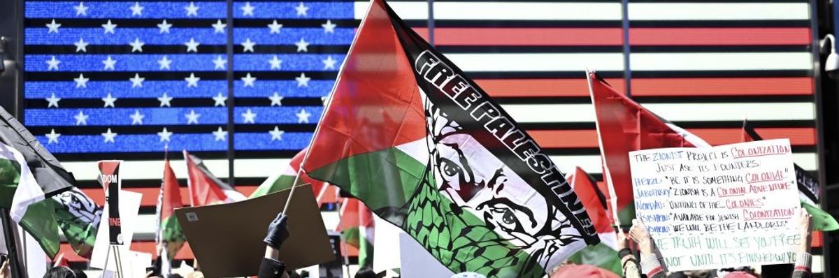 Crowds hold Palestinian flag in Time Square. 