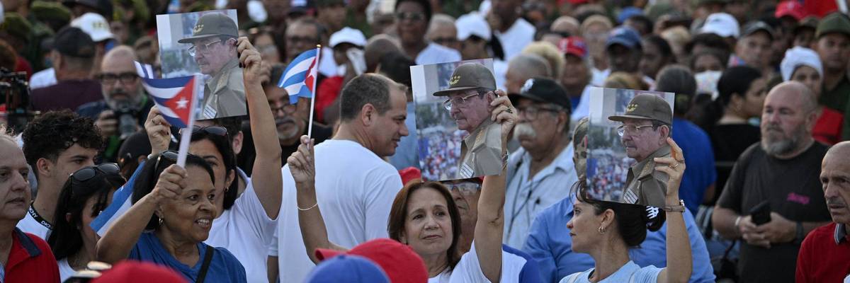 Cubans hold photos of Raúl Castro during a massive rally in Havana against US aggression