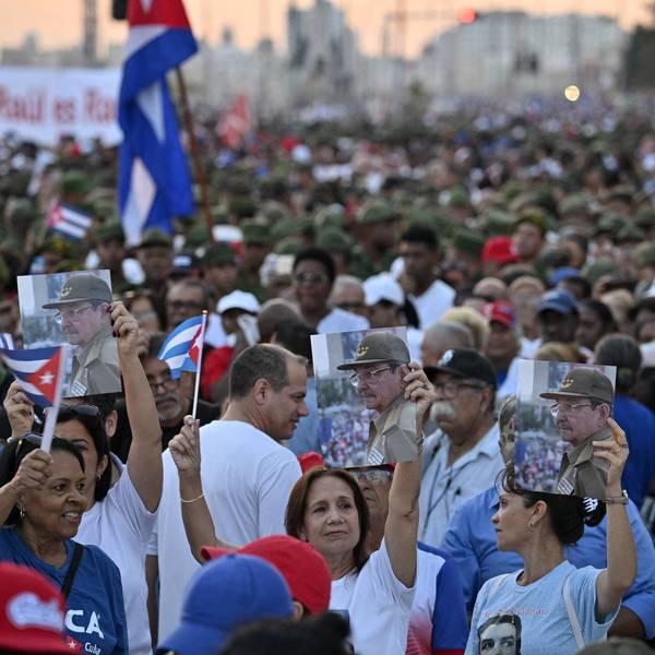 Cubans hold photos of Raúl Castro during a massive rally in Havana against US aggression
