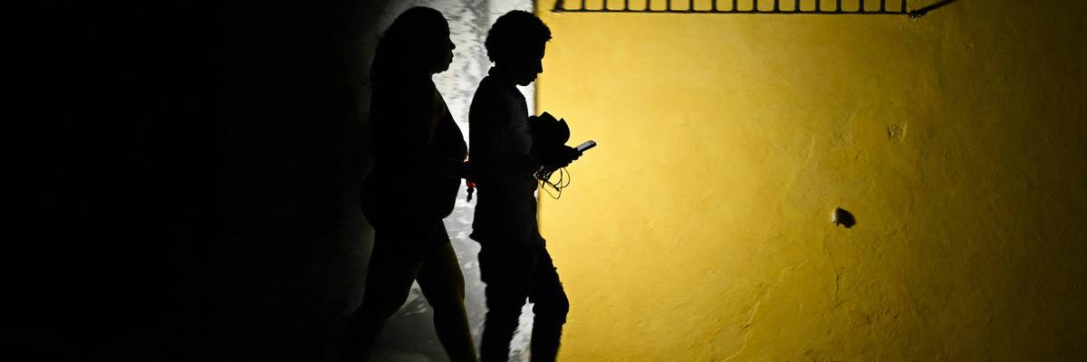 Cubans walk in the dark during a blackout