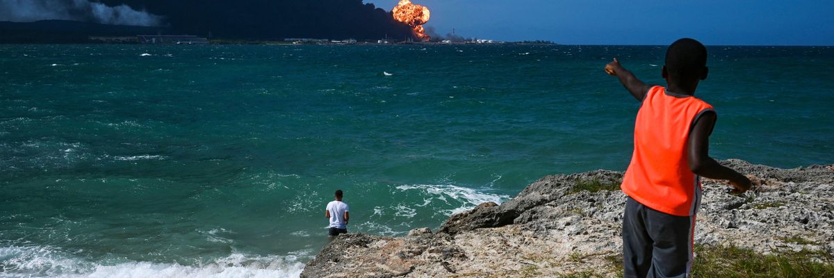 Cubans watch as a massive fire spreads at a fuel depot in Matanzas on August 8, 2022.