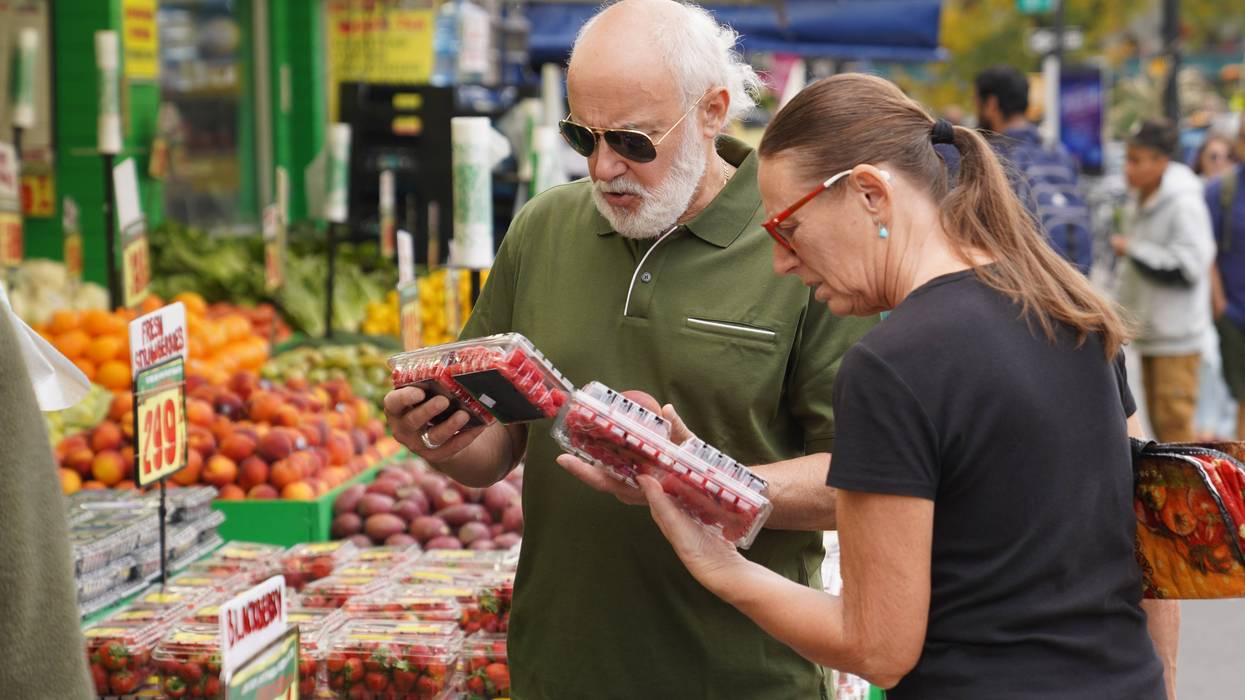Customers check fruit at a grocery store in New York City on October 14, 2026.