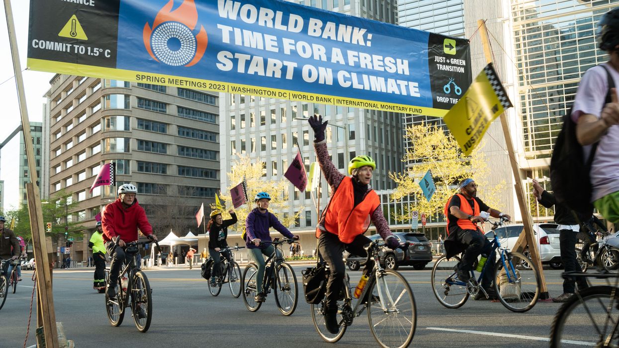 Cyclists take over rush hour traffic outside World Bank headquarters and urge incoming president Ajay Banga to stop funding fossil fuels on April 10, 2023 in Washington, D.C.