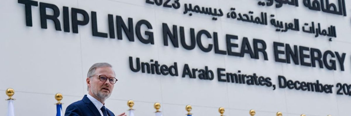 Czech Republic's Prime Minister Petr Fiala speaks under sign reading "Tripling Nuclear Energy"