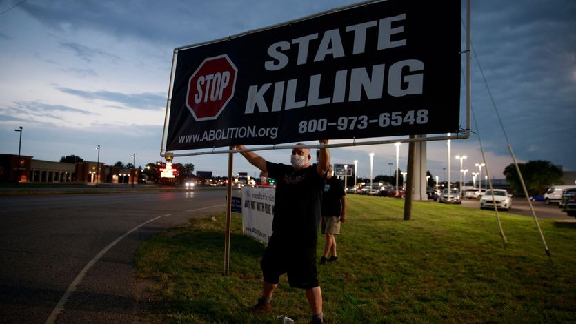 Death penalty abolitionist Abe Bonowitz holds a sign reading, "Stop State Killing"