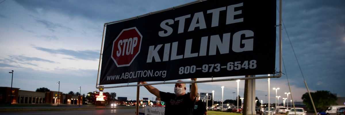 Death penalty abolitionist Abe Bonowitz holds a sign reading, "Stop State Killing"