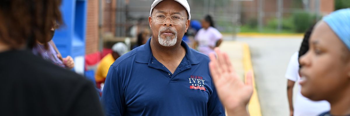 Democratic congressional candidate Glenn Ivey waits to greet a voter at Surrattsville High School on July 19, 2022 in Clinton, Maryland.