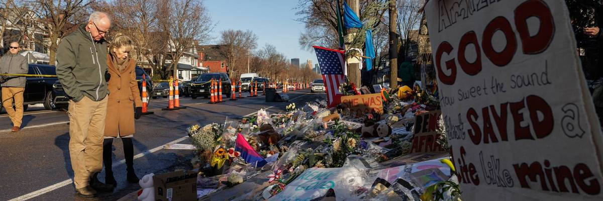 Democratic Minnesota Gov. Tim Walz and his wife, Gwen Walz, visit a makeshift memorial for Renee Good