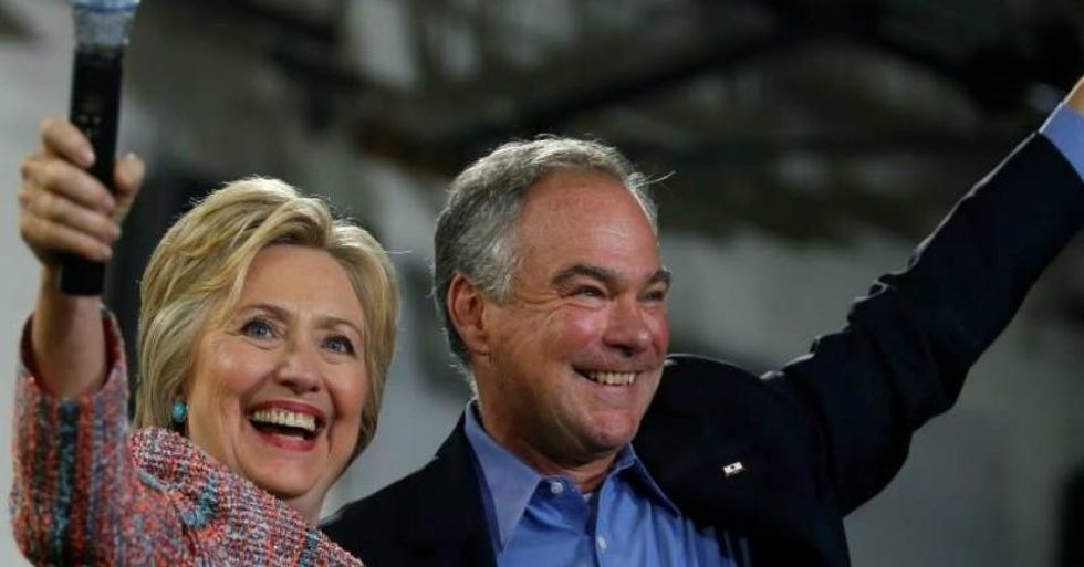 Democratic presidential candidate Hillary Clinton and U.S. Senator Tim Kaine (D-VA) wave to the crowd during a campaign rally at Ernst Community Cultural Center in Annandale, Virginia, U.S., on July 14, 2016. (Photo: Reuters/Carlos Barria)