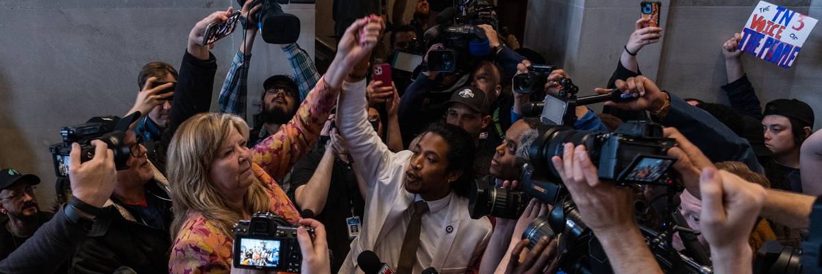 Democratic state Reps. Gloria Johnson of Knoxville and Justin Jones of Nashville raise their arms in defiance