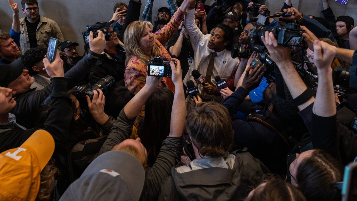 Democratic state Reps. Gloria Johnson of Knoxville and Justin Jones of Nashville raise their arms in defiance