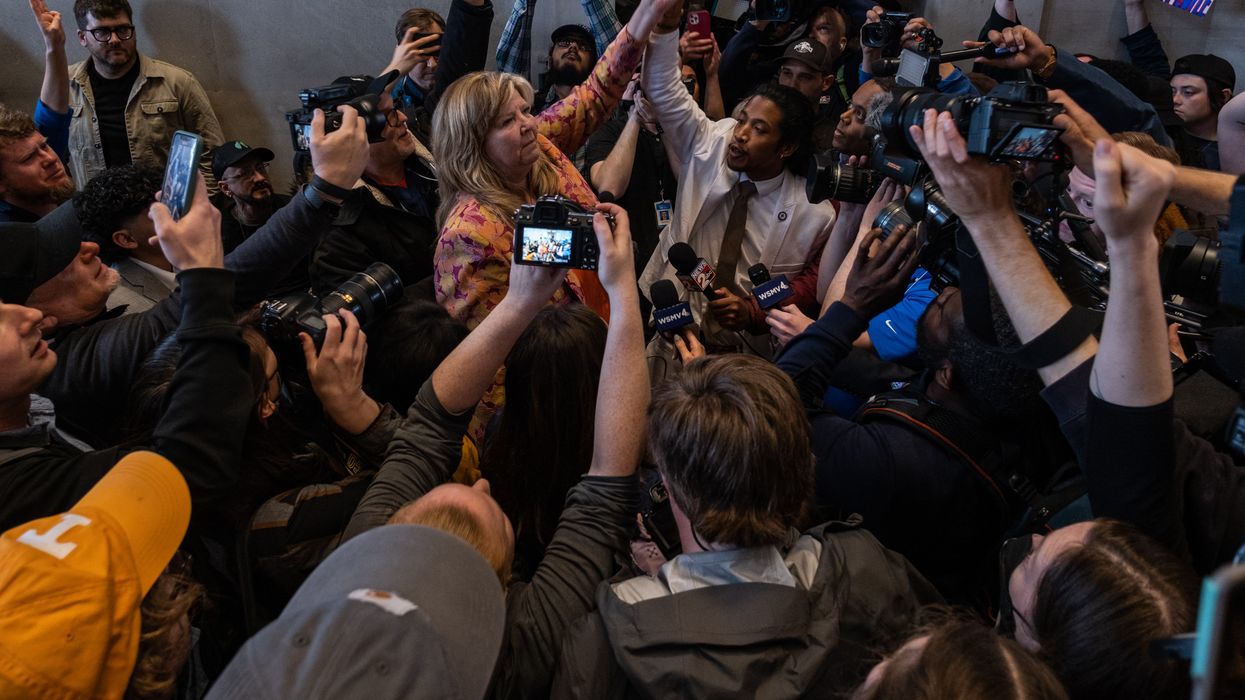 Democratic state Reps. Gloria Johnson of Knoxville and Justin Jones of Nashville raise their arms in defiance