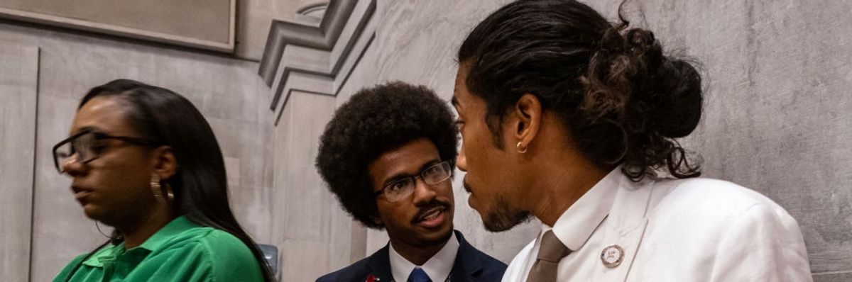 Democratic state Reps. Justin Pearson (C) of Memphis and Justin Jones (R) of Nashville attend the vote in which they were expelled from the state Legislature on April 6, 2023 in Nashville, Tennessee.