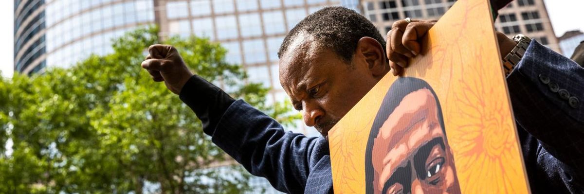 Demonstrator holds image of George Floyd