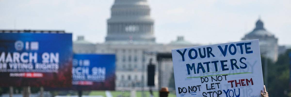 Demonstrators attend a rally for voting rights