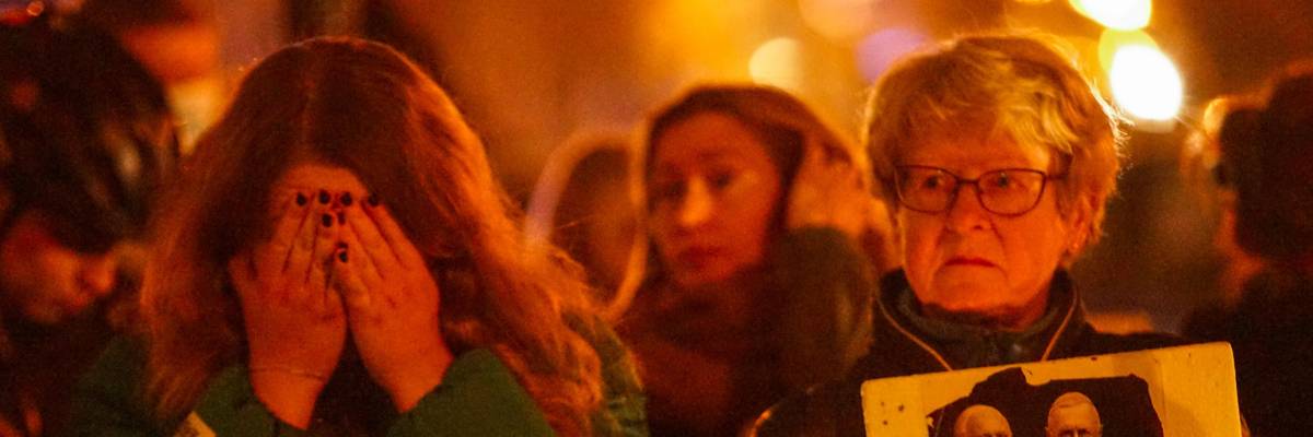 Demonstrators attend a vigil in Poland for a woman who died after doctors refused to give her an abortion