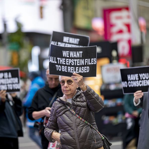 Demonstrators carry signs calling out Donald Trump's refusal to release files from the federal case against deceased sex offender Jeffrey Epstein