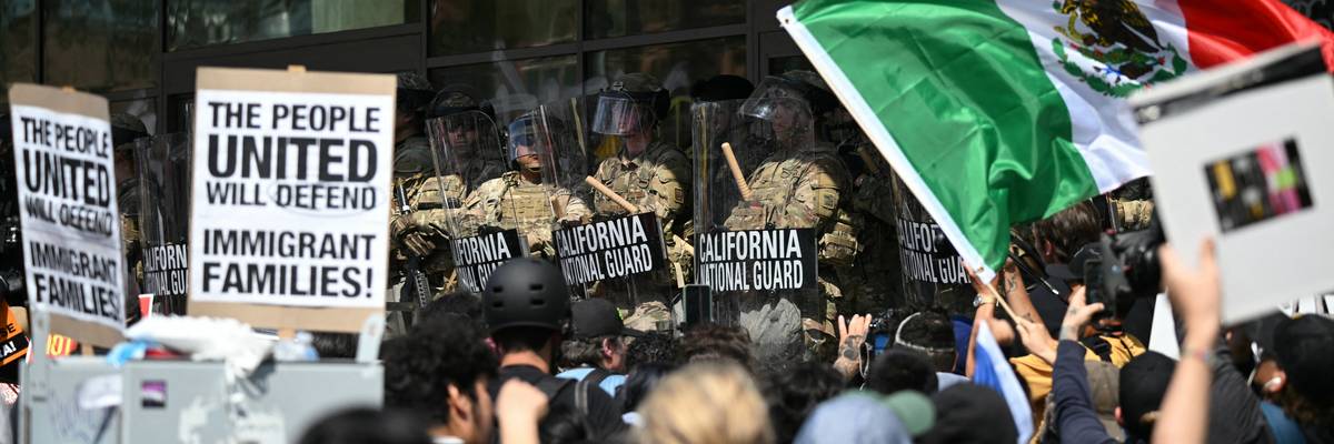 Demonstrators face California National Guard members