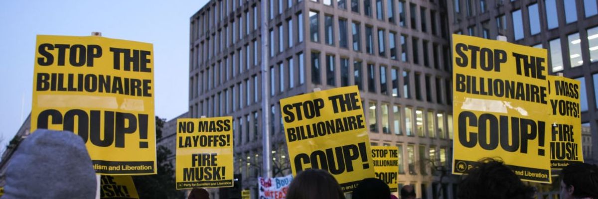 Demonstrators gather outside of the Office of Personnel Management