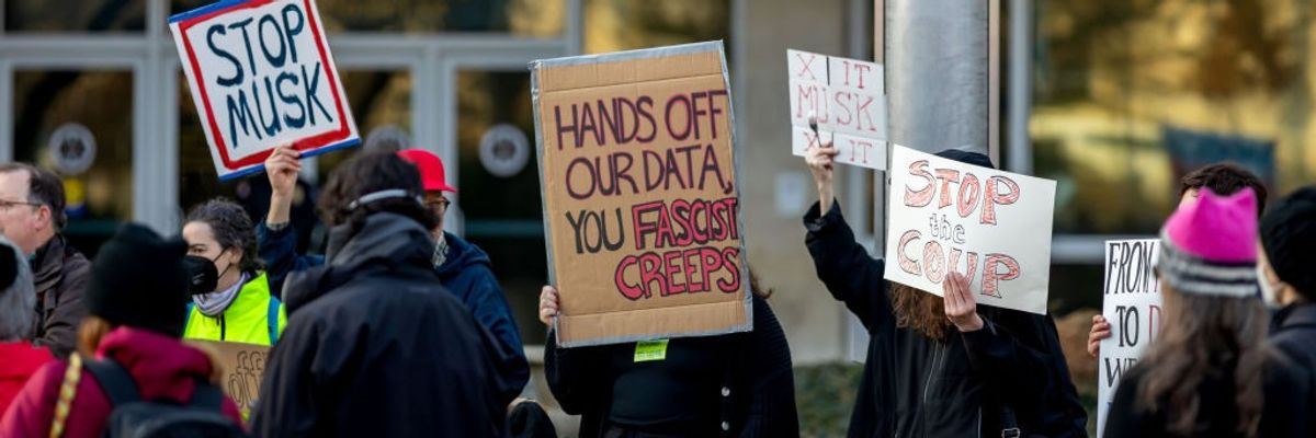 Demonstrators gather outside U.S. Office of Personal Management headquarters