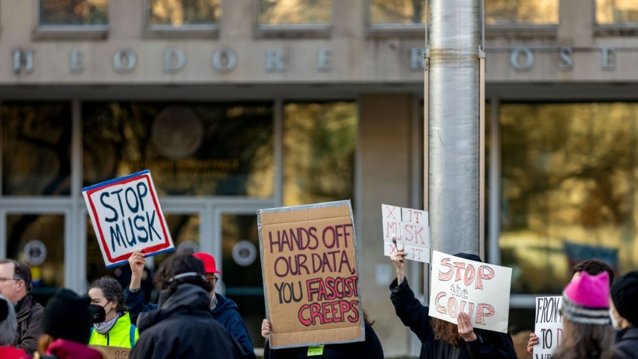 Demonstrators gather outside U.S. Office of Personal Management headquarters