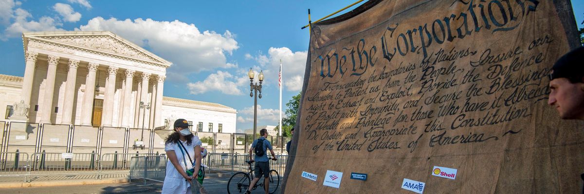 Demonstrators hold a mock Constitution outside the U.S. Supreme Court