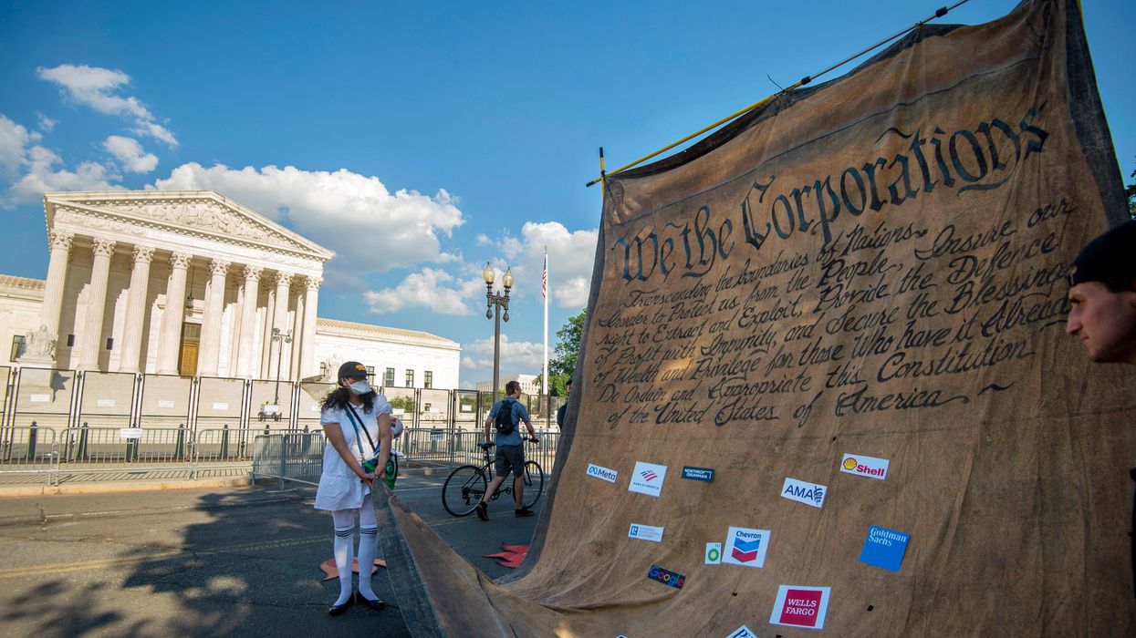 Demonstrators hold a mock Constitution outside the U.S. Supreme Court