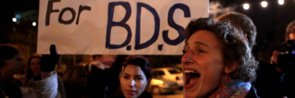 Demonstrators hold a placard urging the